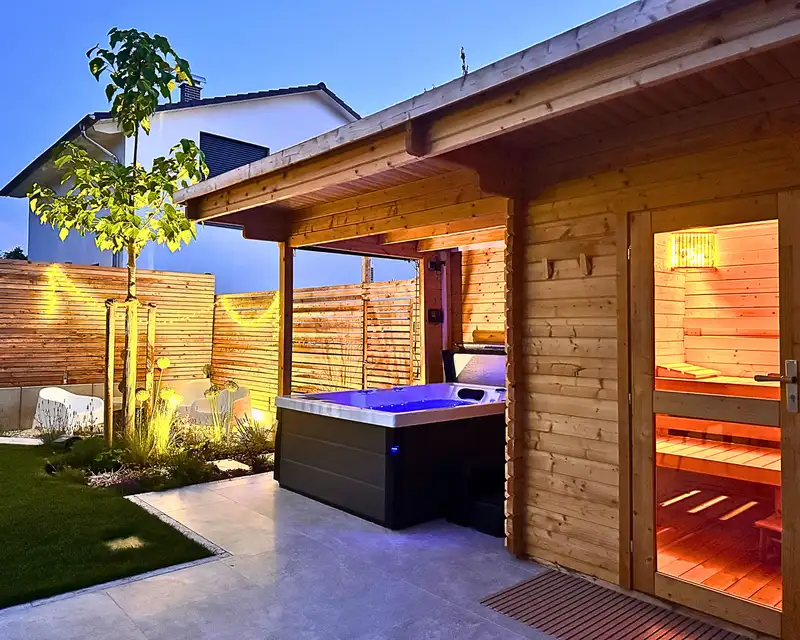 Private Sauna und Whirlpool im Garten des Apartments WolkenGarten am Abend